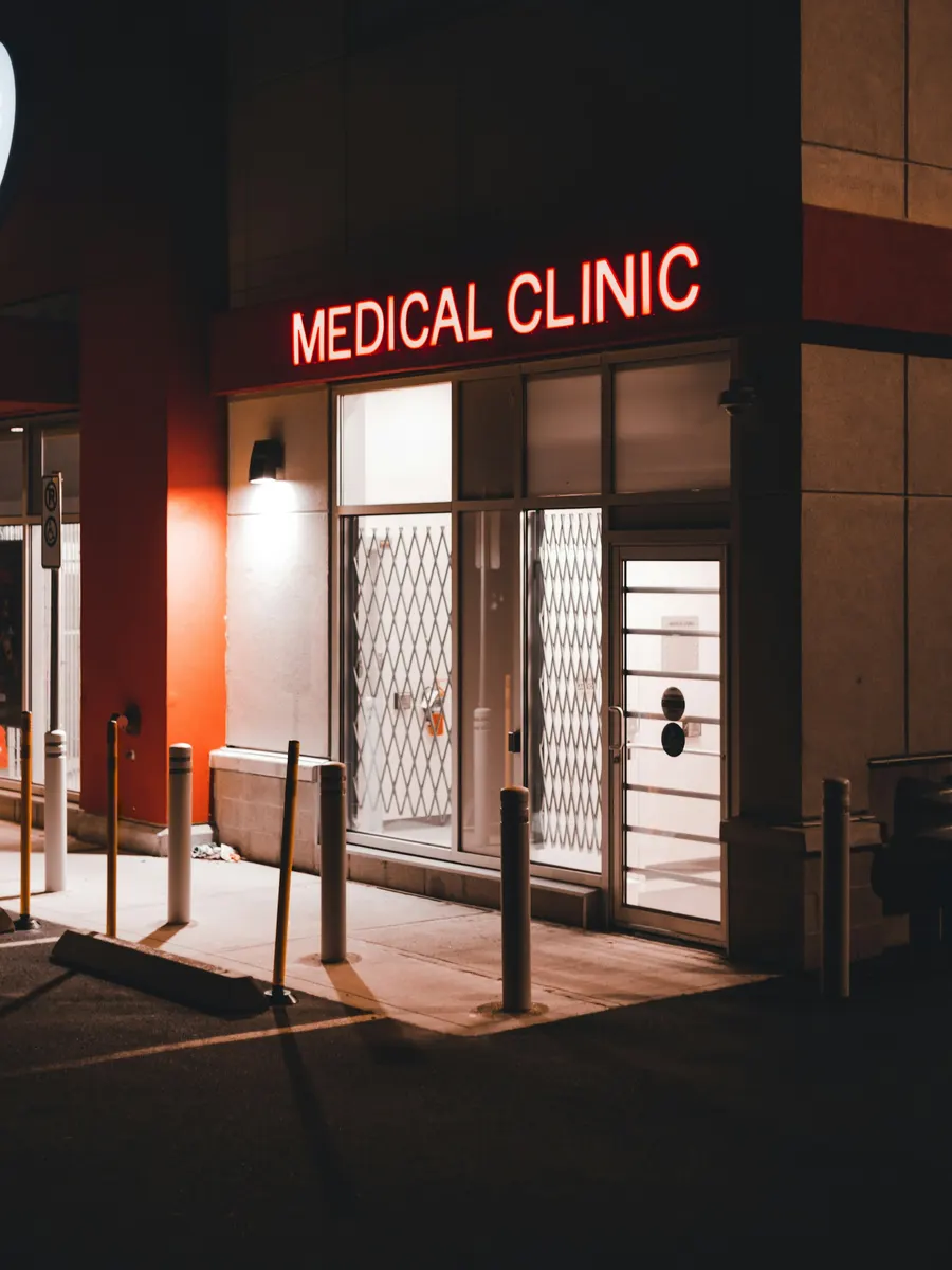 A clinic storefront lit up in the evening
