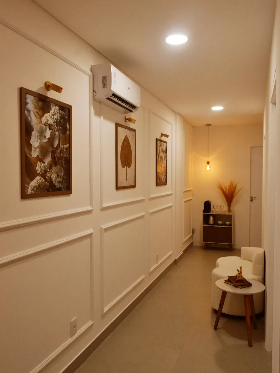 A calm, warmly lit clinic corridor with framed botanical prints and seating